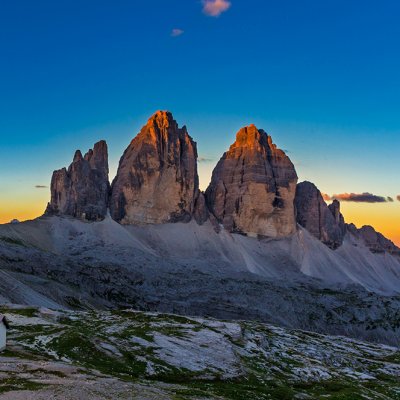 Panoramic view of  Tre Cime and  rifugio hut before sunrise, Tre Cime di Lavaredo National Park, Dolomites, Italy